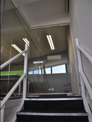 Simon Wang office space with designer furniture, flooring, suspended grid celing and glass partitions 9
