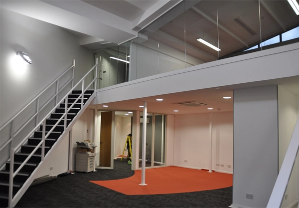 Simon Wang office space with designer furniture, flooring, suspended grid celing and glass partitions