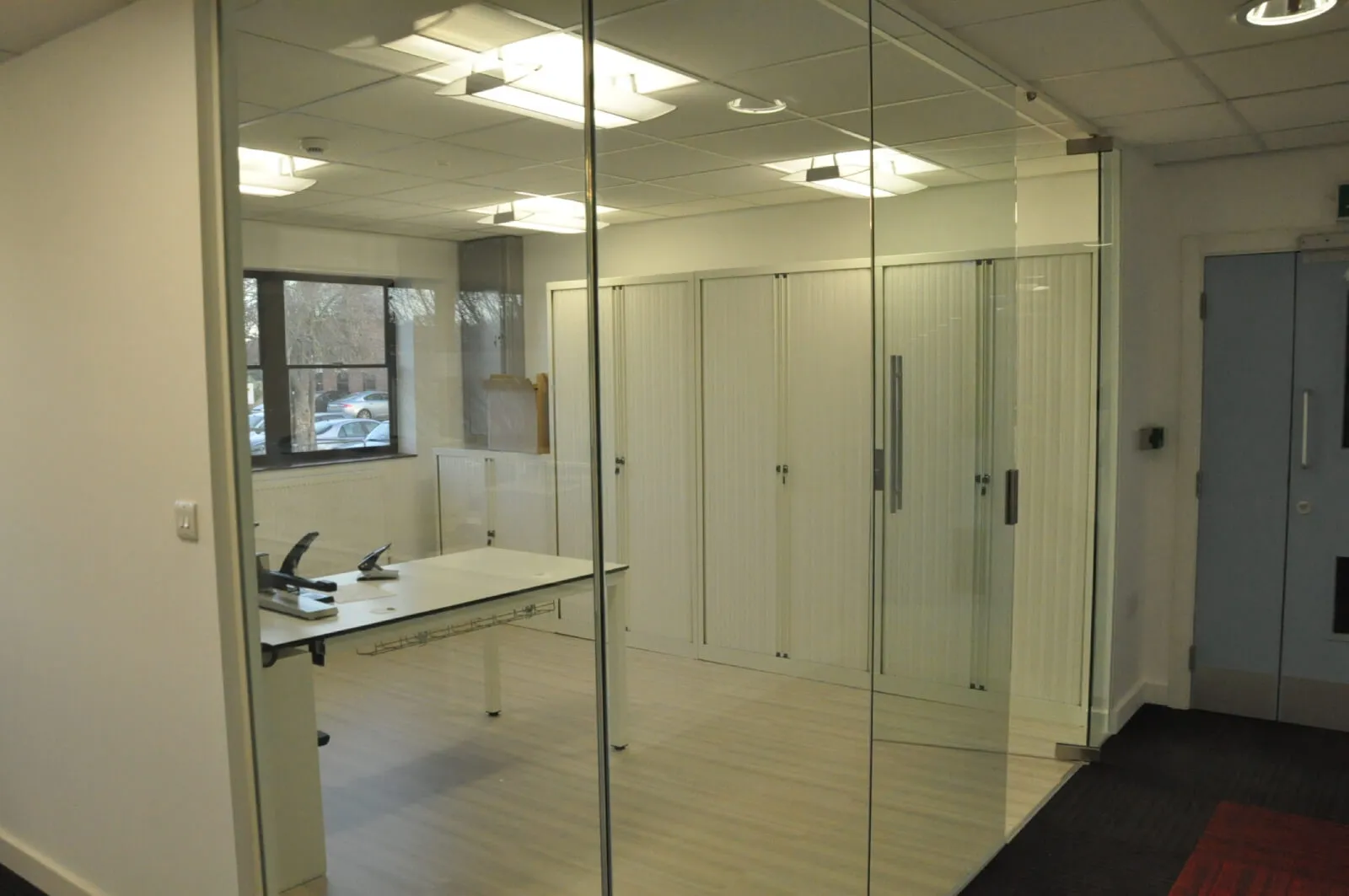 Tansales office with single glazed with frameless doors glass partitions and desinger furniture 16