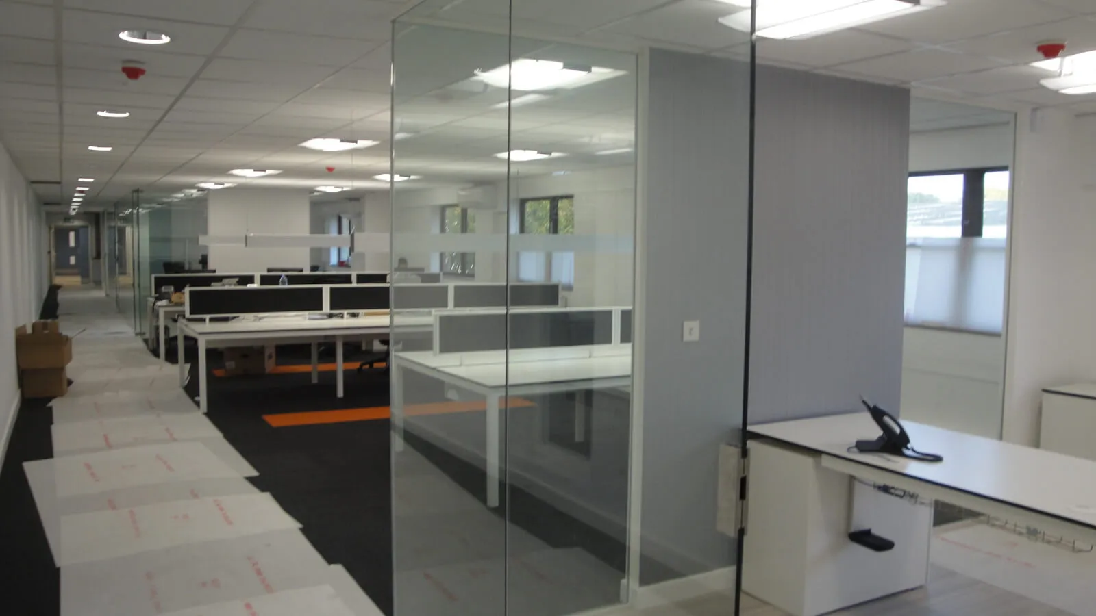 Tansales office with single glazed with frameless doors glass partitions and desinger furniture 37