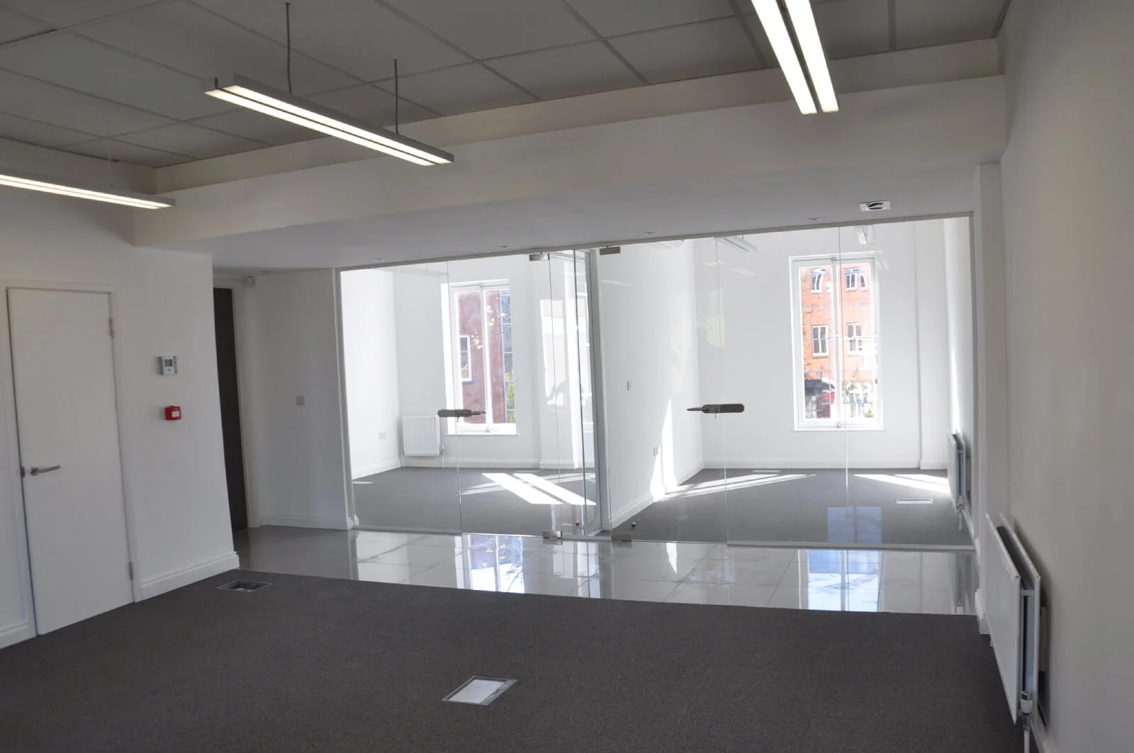 World Sim office with single glazed with frameless doors glass partitions and desinger furniture 1