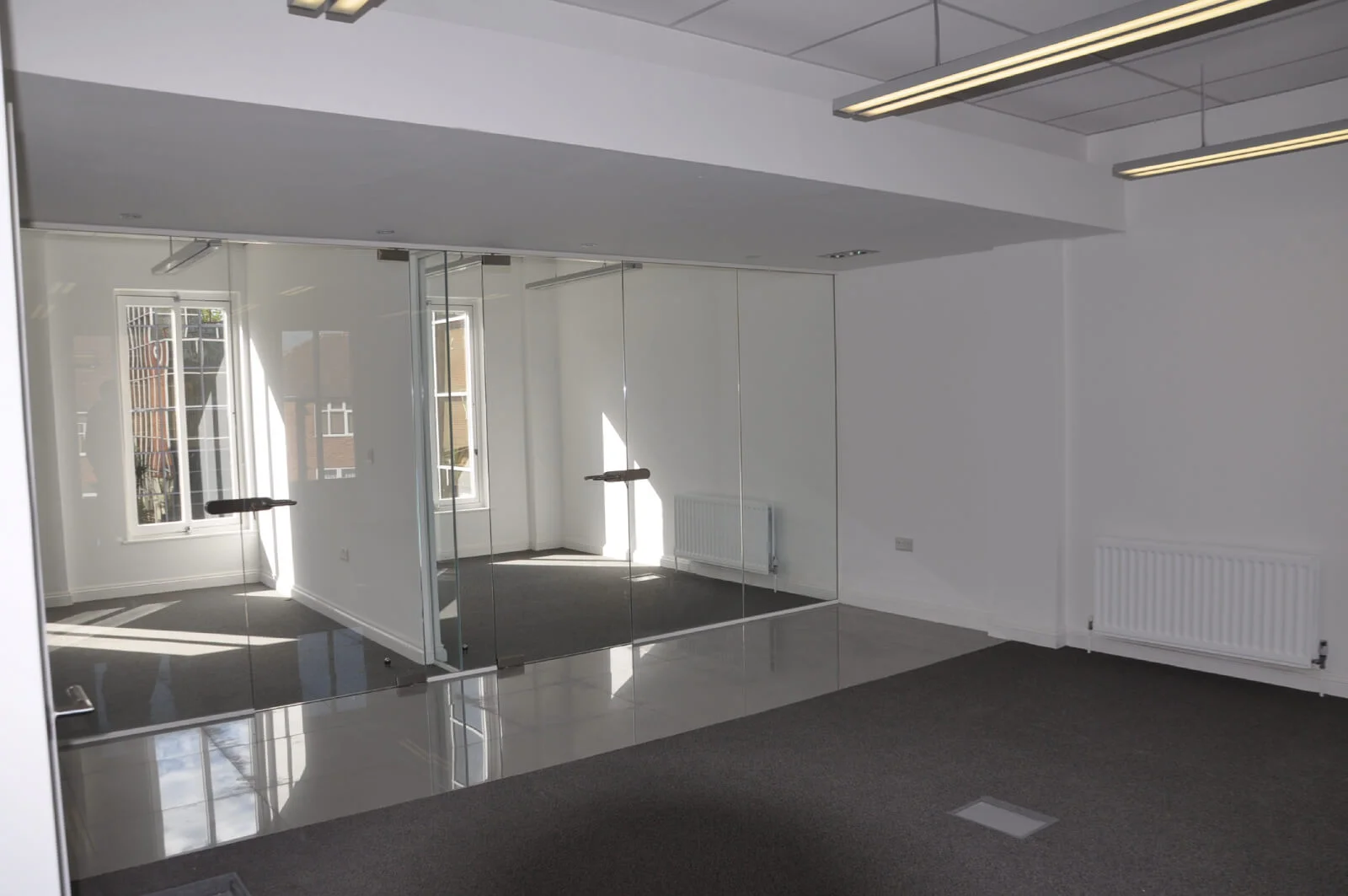 World Sim office with single glazed with frameless doors glass partitions and desinger furniture 2