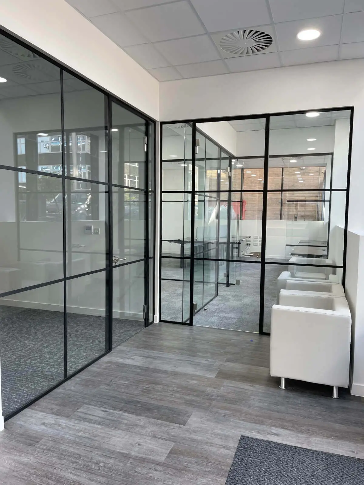 Carter Bond space design with suspended grid ceiling black framed glass partitions 1