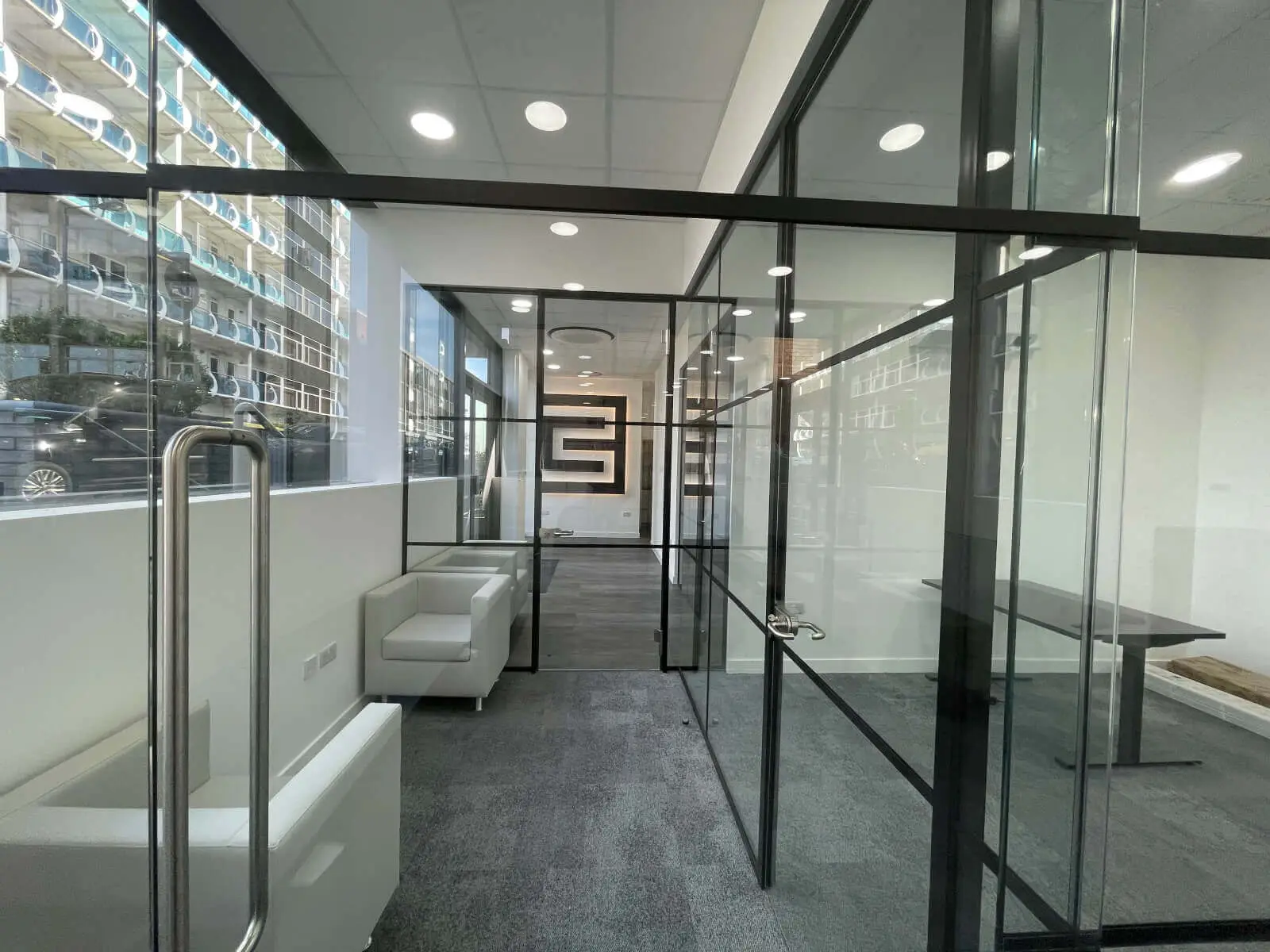 Carter Bond space design with suspended grid ceiling black framed glass partitions 12