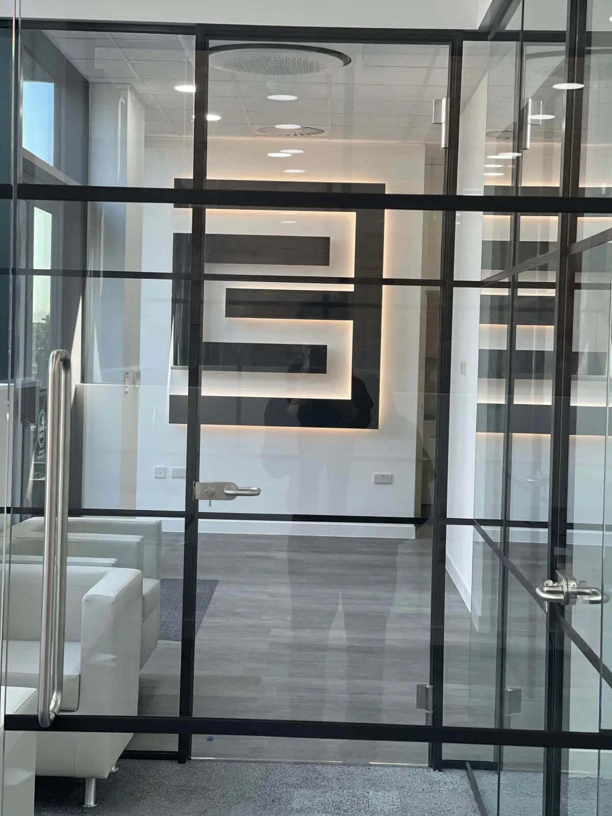 Carter Bond space design with suspended grid ceiling black framed glass partitions 13