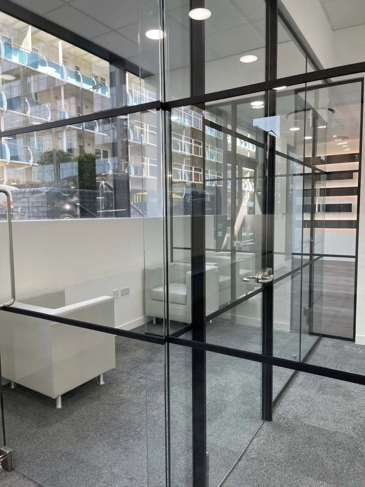 Carter Bond space design with suspended grid ceiling black framed glass partitions 14