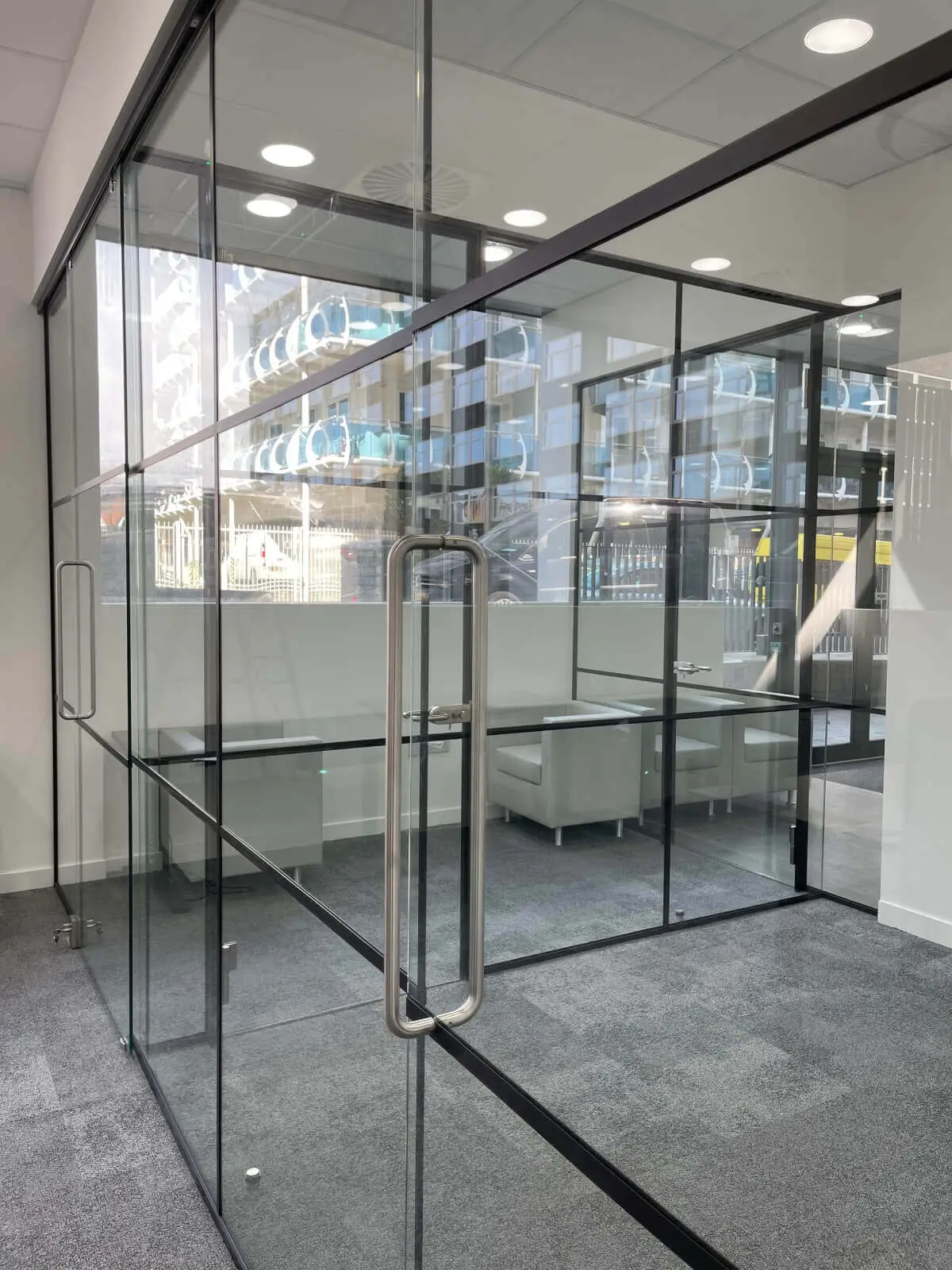 Carter Bond space design with suspended grid ceiling black framed glass partitions 15