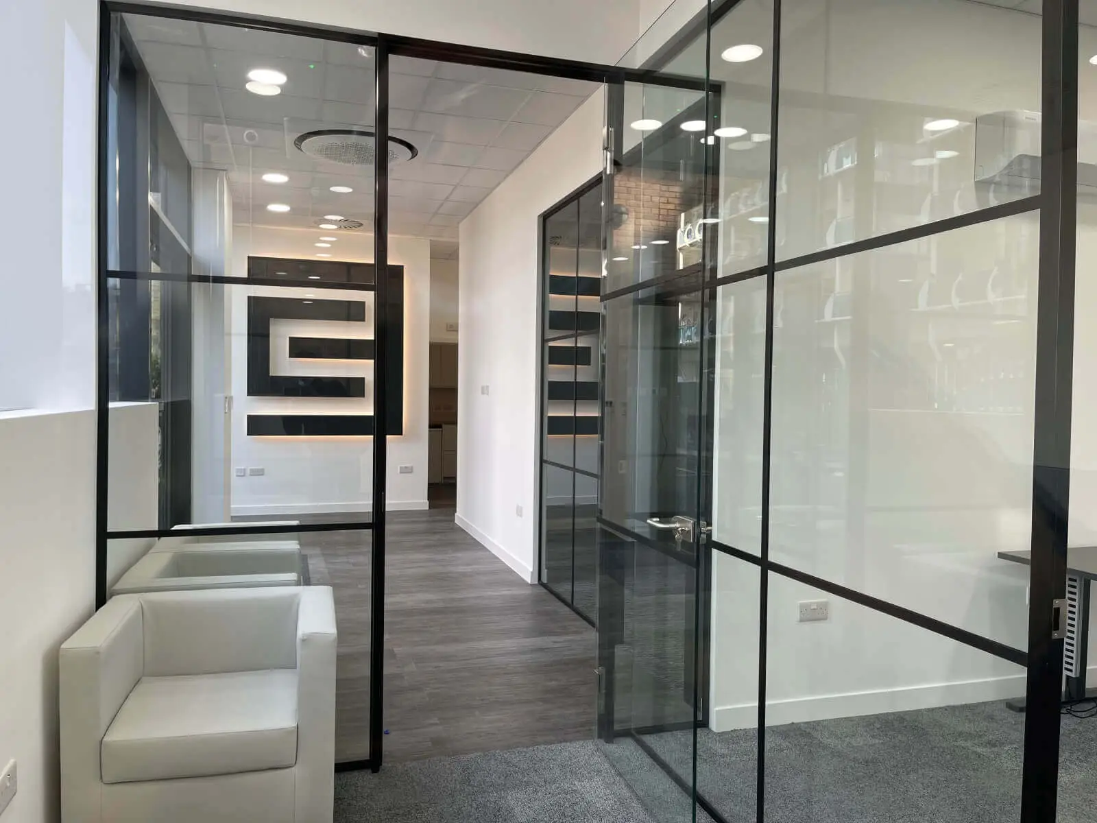 Carter Bond space design with suspended grid ceiling black framed glass partitions 16
