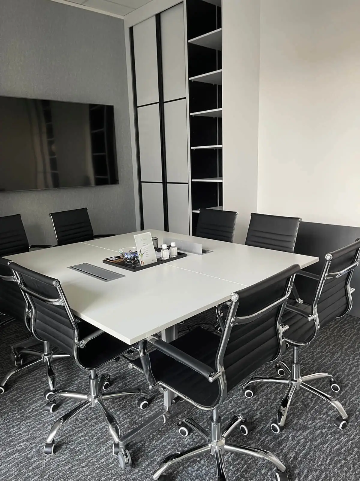 Carter Bond space design with suspended grid ceiling black framed glass partitions 17