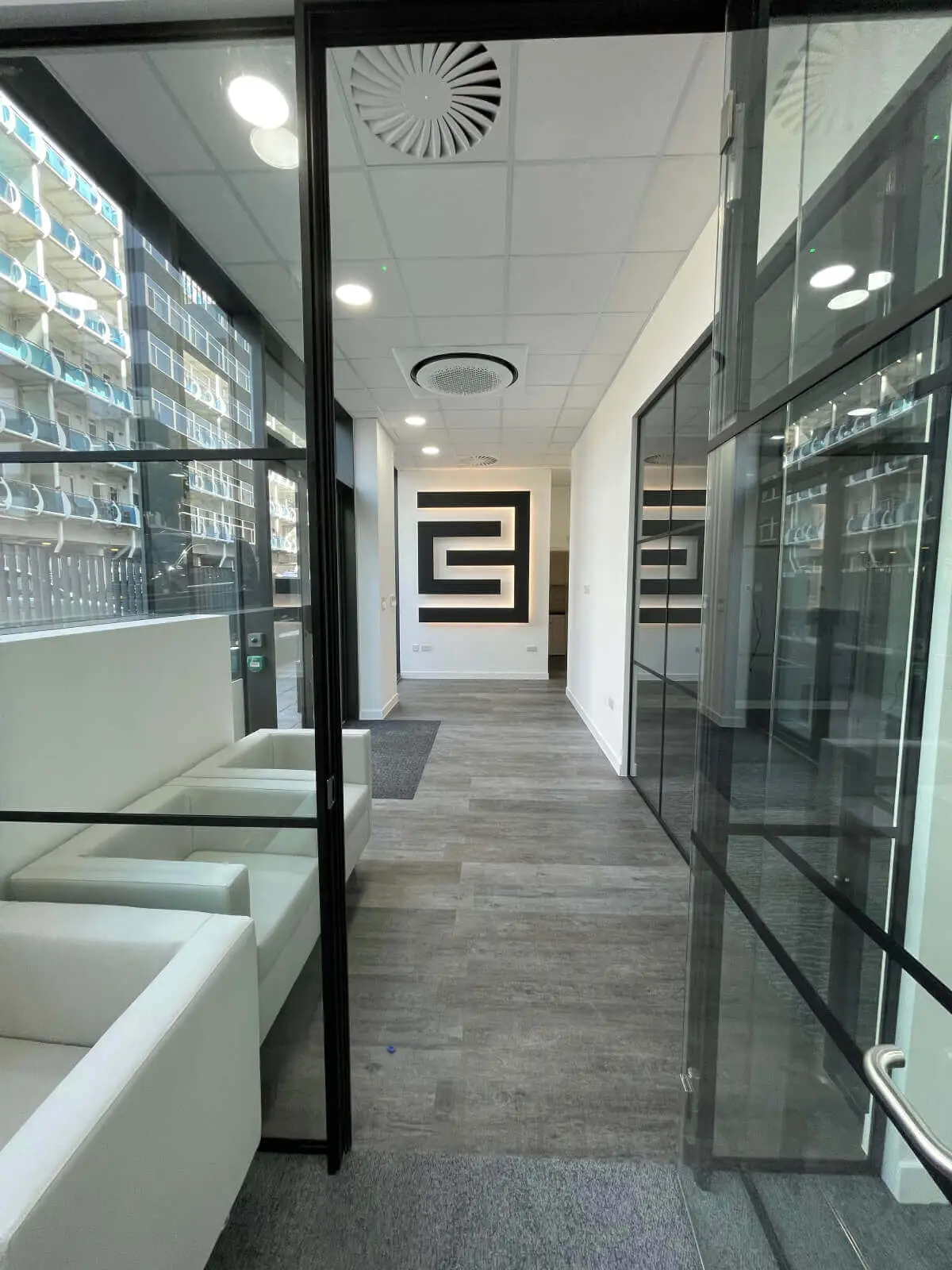 Carter Bond space design with suspended grid ceiling black framed glass partitions 2