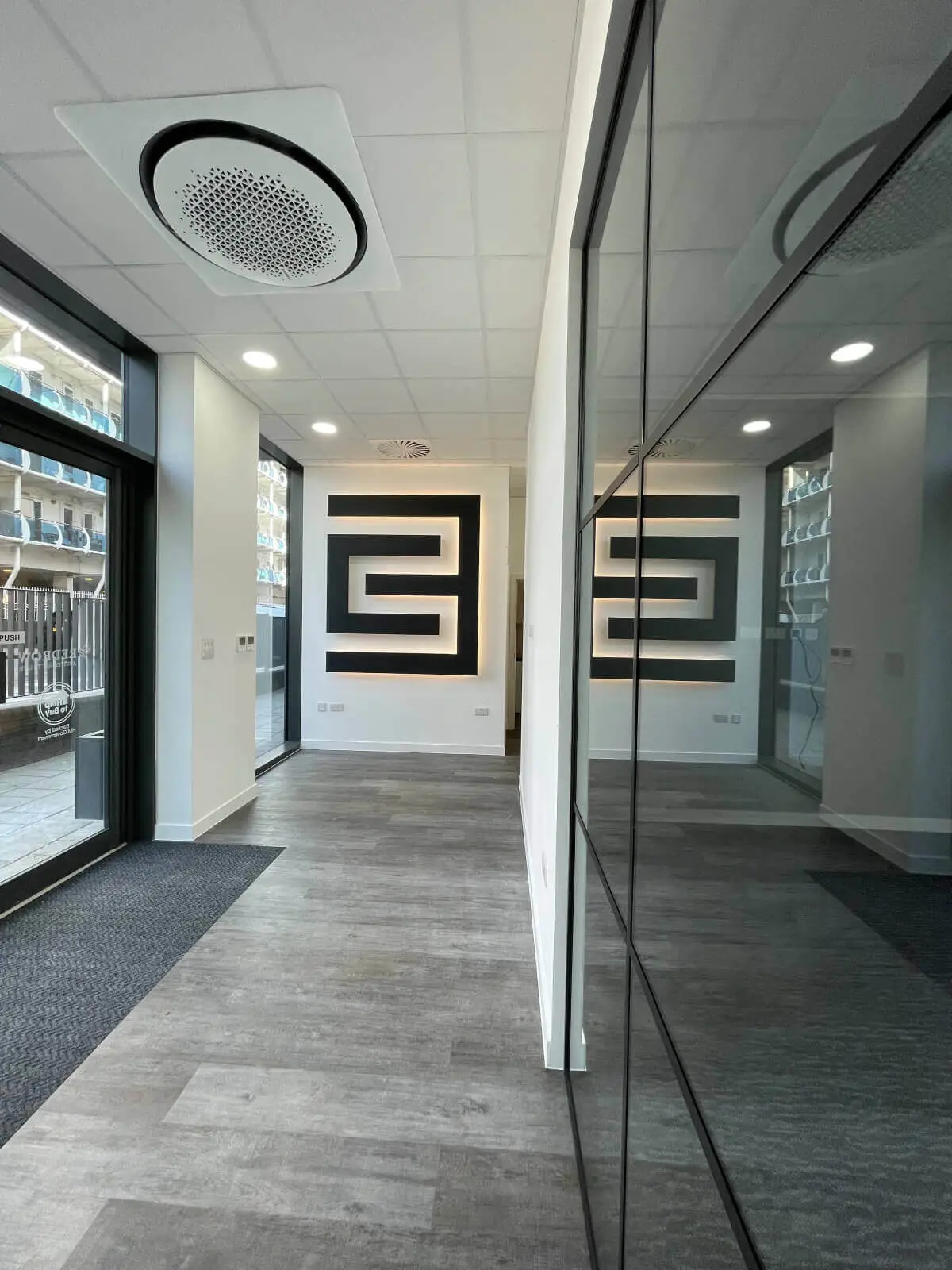 Carter Bond space design with suspended grid ceiling black framed glass partitions 3