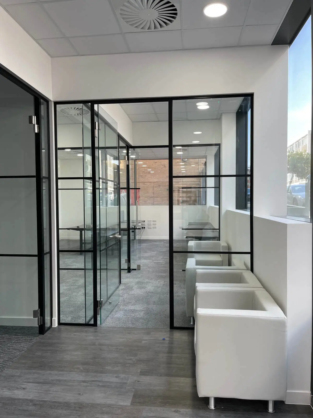 Carter Bond space design with suspended grid ceiling black framed glass partitions 5