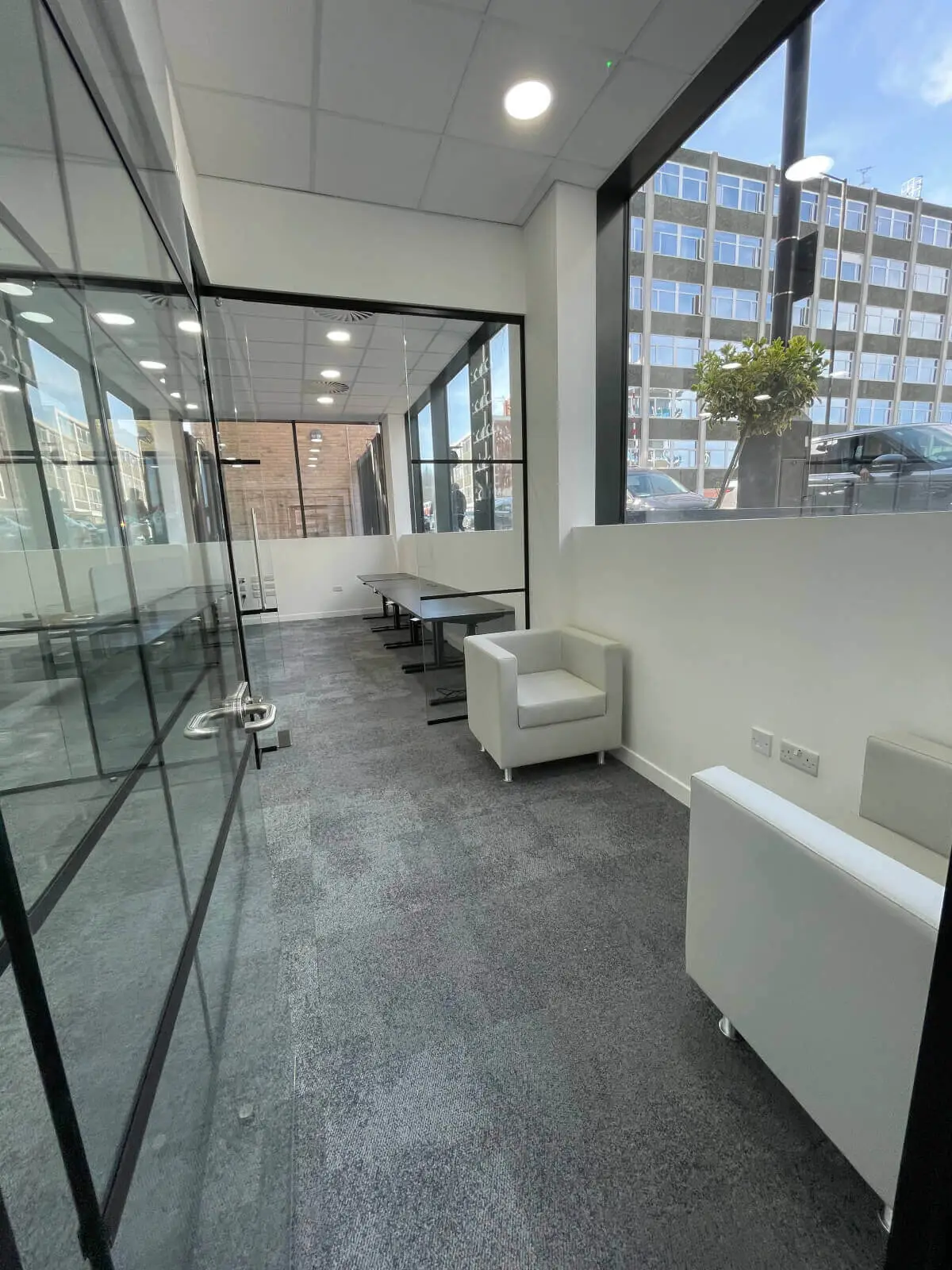 Carter Bond space design with suspended grid ceiling black framed glass partitions 6