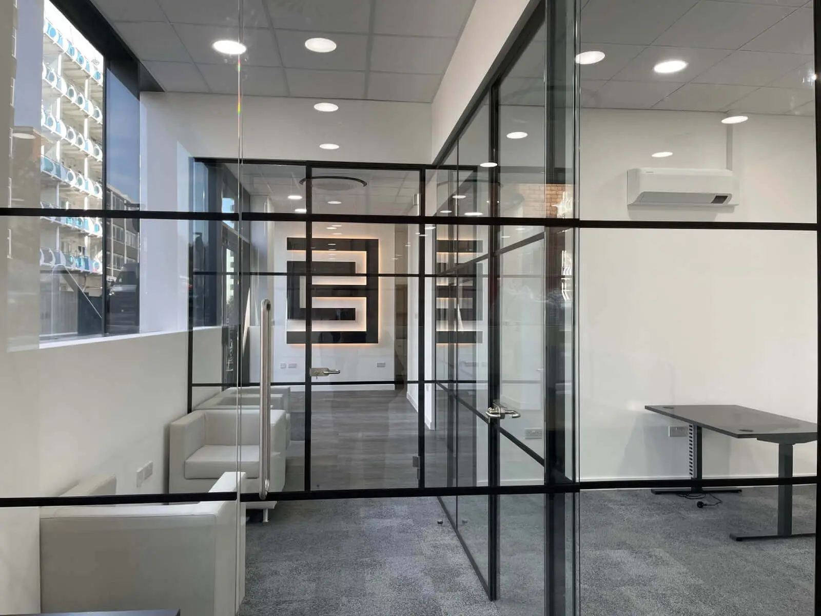 Carter Bond space design with suspended grid ceiling black framed glass partitions 7