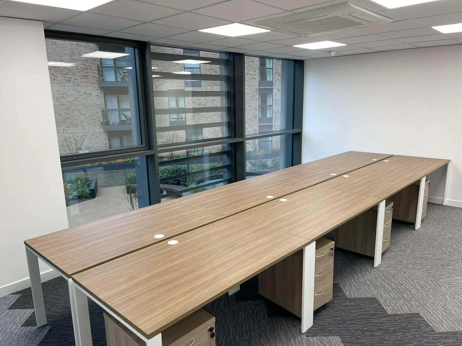 Hemsley Miller office space with designer flooring, funriture and single glazed glass partitions 1