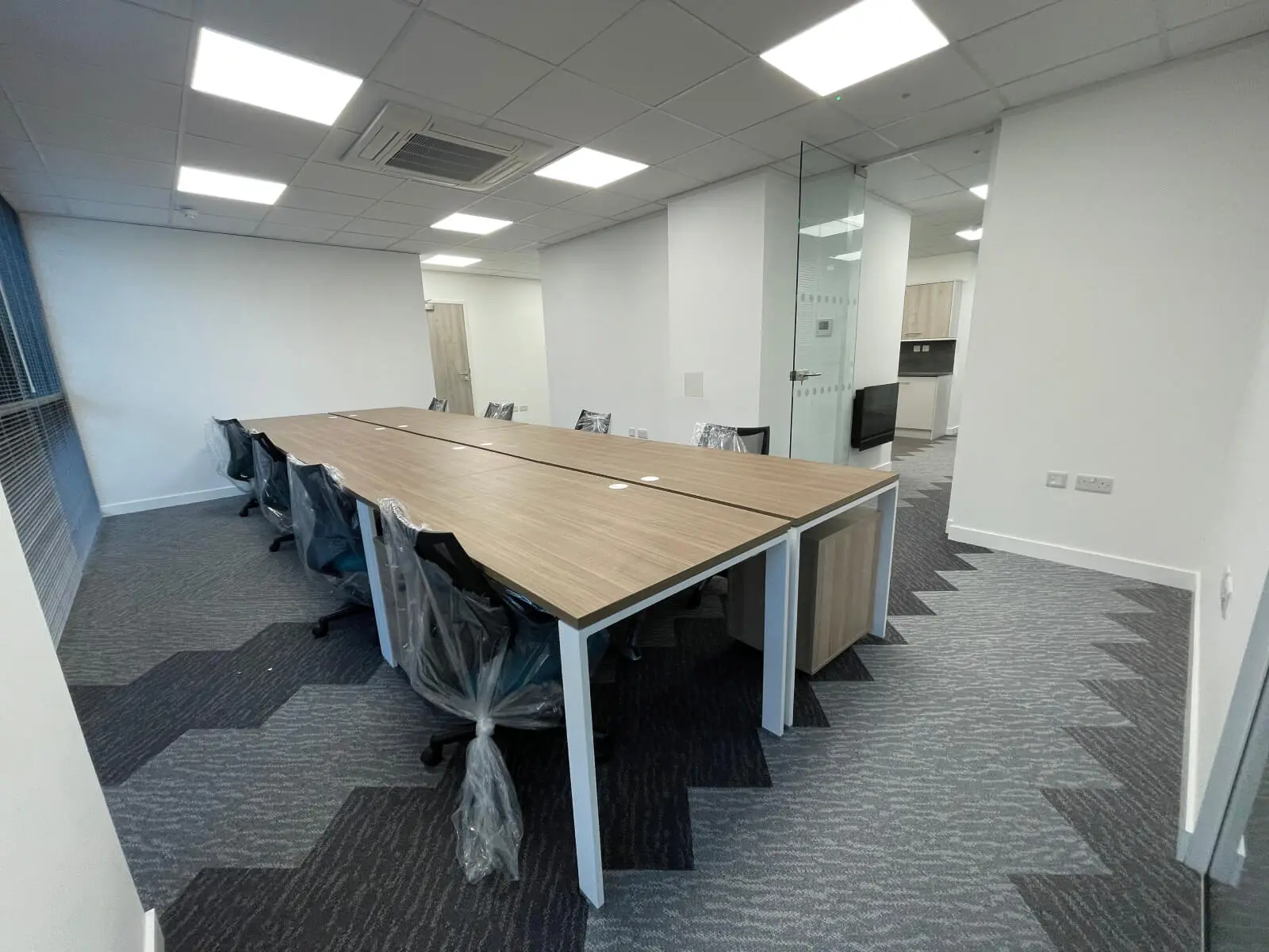 Hemsley Miller office space with designer flooring, funriture and single glazed glass partitions 10