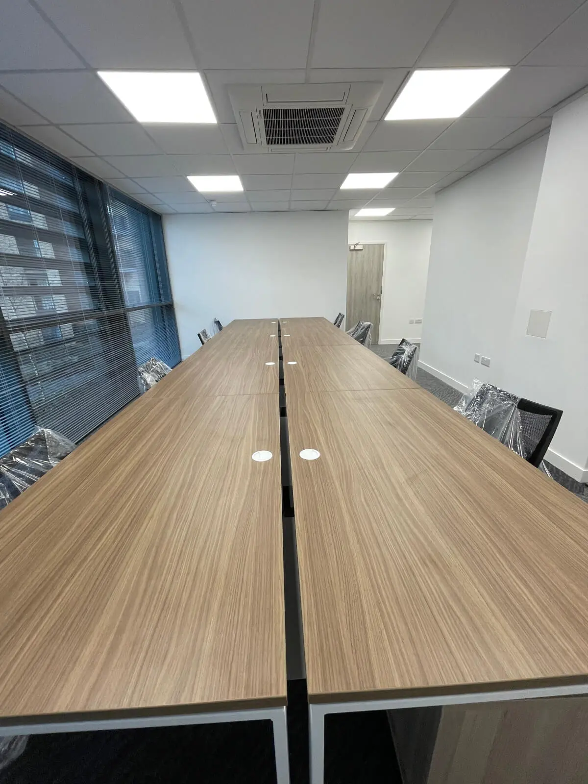 Hemsley Miller office space with designer flooring, funriture and single glazed glass partitions 11