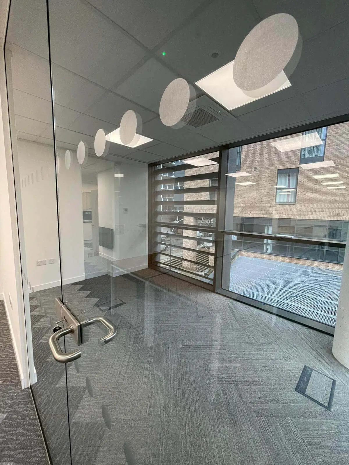 Hemsley Miller office space with designer flooring, funriture and single glazed glass partitions 18