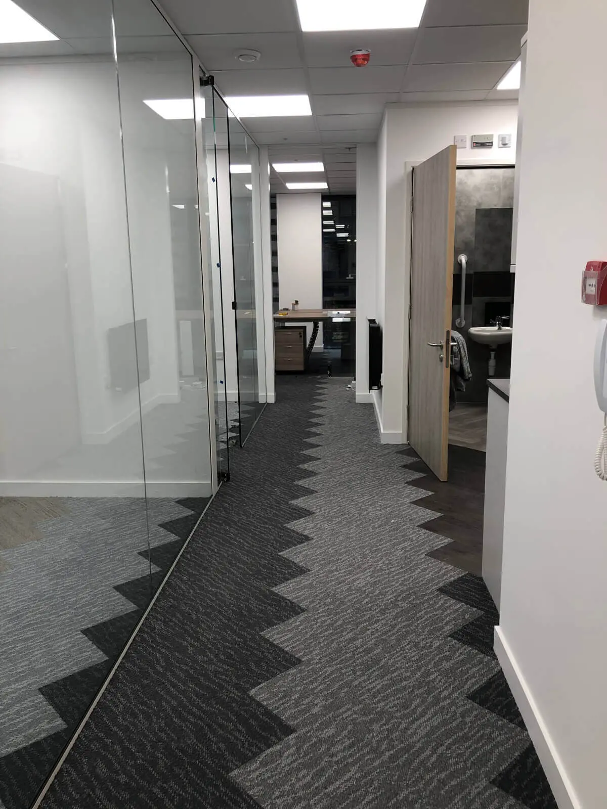 Hemsley Miller office space with designer flooring, funriture and single glazed glass partitions 3