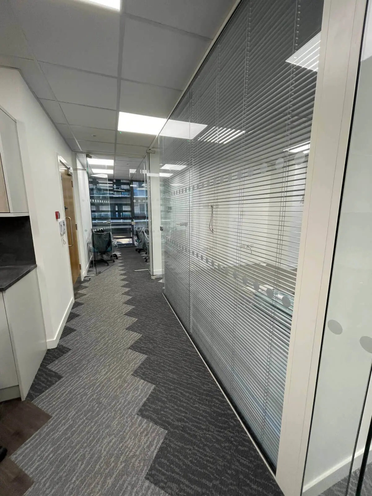 Hemsley Miller office space with designer flooring, funriture and single glazed glass partitions 9